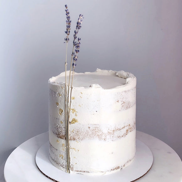 Vegan semi-naked cake decorated with gold leaf and dried lavender stems made to order in Trinidad