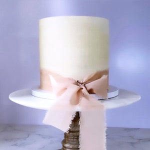 Vegan vanilla buttercream cake wrapped with beautiful bow made to order in Trinidad