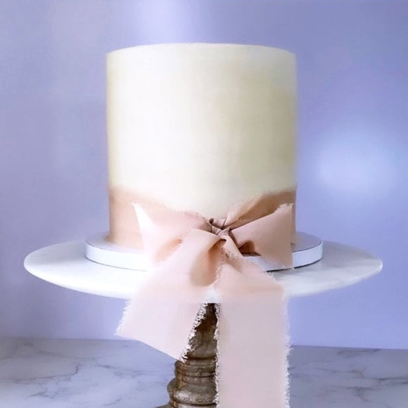 Vegan vanilla buttercream cake wrapped with beautiful bow made to order in Trinidad